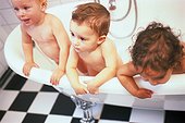 Three toddlers in the bathtub