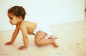 Crawling baby on wooden floor