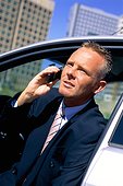 Businessman talking to someone on the phone in the car