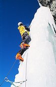 Climber on icy rockface