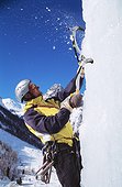 Climber on icy rockface