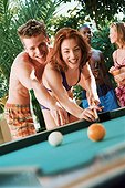 Young couple playing billiards