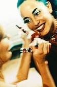 Young woman being put makeup on