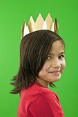 Smiling little girl wearing a paper crown