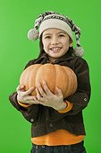 Little girl holding a pumpkin