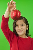 Little girl holding a Christmas ornament