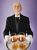 Butler holding tray of brandy