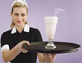 Waitress serving a milk shake