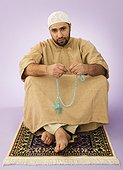 Muslim man holding prayer beads