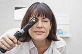 Eye doctor looking through an ophthalmoscope