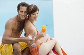 Couple having drinks by the pool