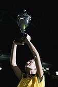 Soccer player holding up a trophy