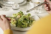 Woman eating a salad with croutons