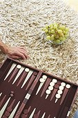 Backgammon Board (cropped) and Bowl with Grapes laying on a Carpet