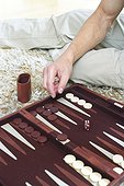 Man playing Backgammon (cropped, detail)