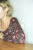 Blonde Woman sitting at a Table (cropped)