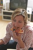 Blonde Woman eating Pizza