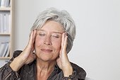 Senior woman massaging her face