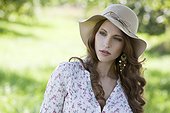 Brunette young woman wearing hat outdoors