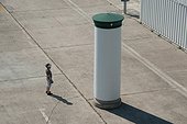 Person standing at blank advertising column, urban development area Aspen airfield, Vienna, Austria