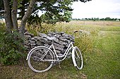 Old fashioned bicycle next to stone boundary