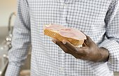 Close up of man''s hand holding sandwich