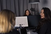 Female coworkers talking in office