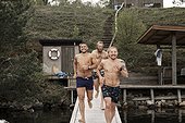 Happy men running on jetty