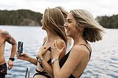 Happy female friends at lake