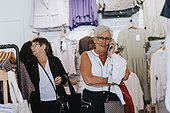 Senior woman in clothes shop