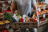 Man carrying crate with organic vegetable