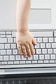 close up of baby\'s hand on keyboard