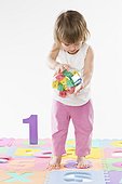 baby girl playing with bricks, letters and numbers