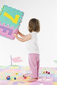 toddler girl playing with letters and numbers