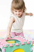 toddler girl playing with letters and numbers