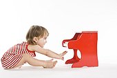 toddler girl playing on piano