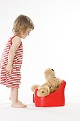 child teaching teddy bear how to use potty