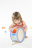 baby playing on drum
