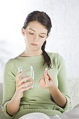 young woman taking pill