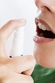 young woman using mouth freshener