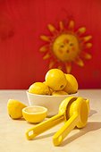 Bowl of lemons and lemon juicer on counter