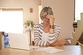 Woman at home office with credit cards