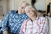 Senior couple relaxing together on sofa in living