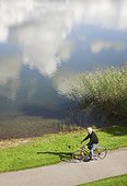 High angle view of senior man cycling near lake