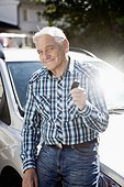 Portrait of smiling senior man showing car key