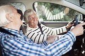 Active senior couple smiling in car