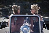 Rear view of female friends on yacht