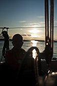 Silhouette image of man standing on boat