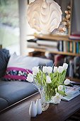 White Tulips in vase over coffee table