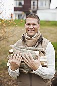 Portrait of happy man carrying firewood